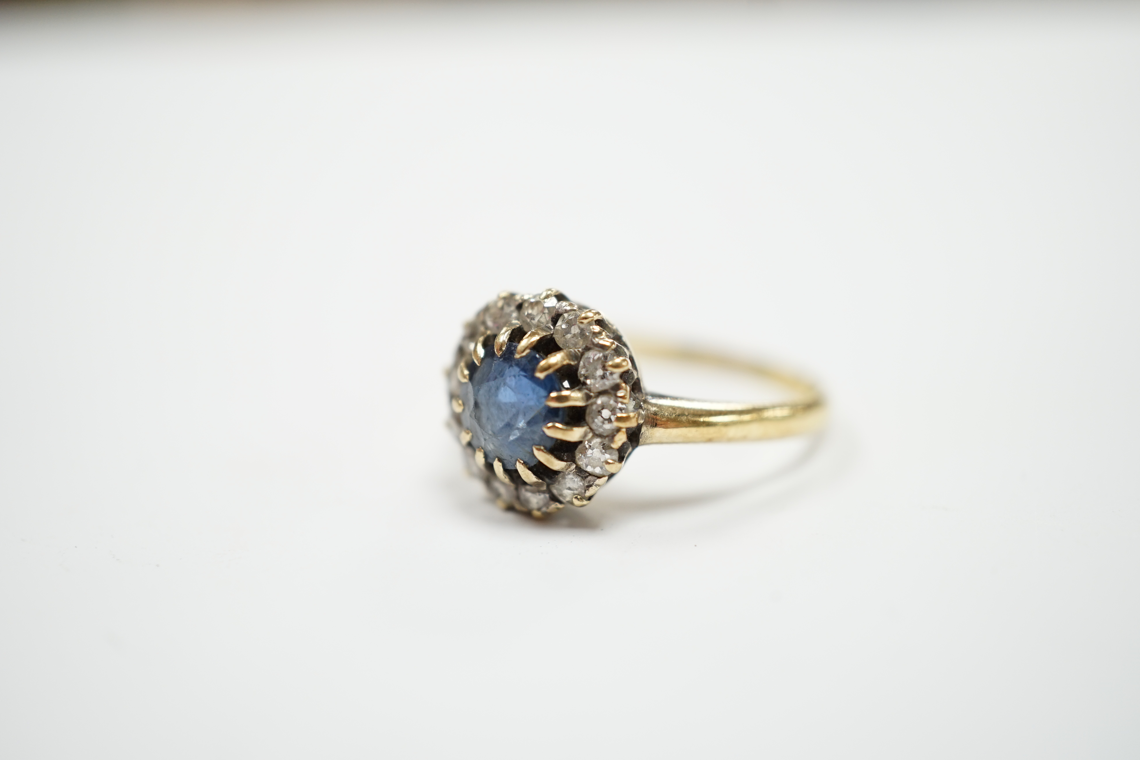 An early 20th century 18ct, sapphire and diamond set circular cluster ring, size P, gross weight 3.3 grams.